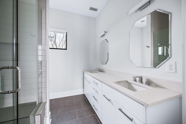 full bath featuring visible vents, a sink, and a shower stall