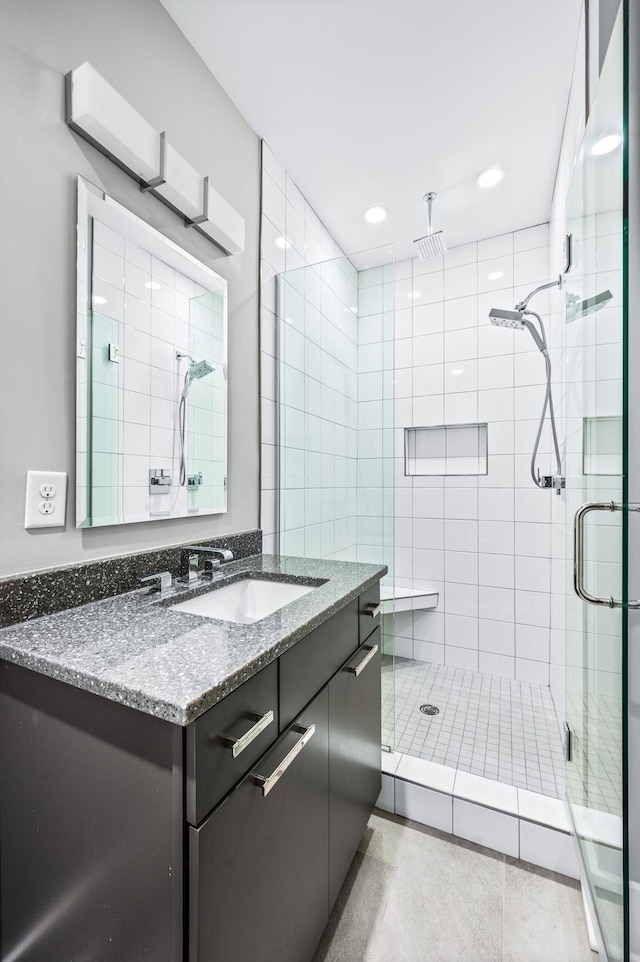 full bath with a stall shower, vanity, and recessed lighting