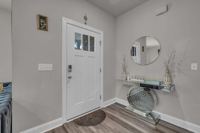 entryway featuring baseboards and wood finished floors