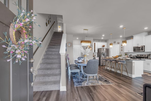 dining area with stairs, dark wood-type flooring, and recessed lighting