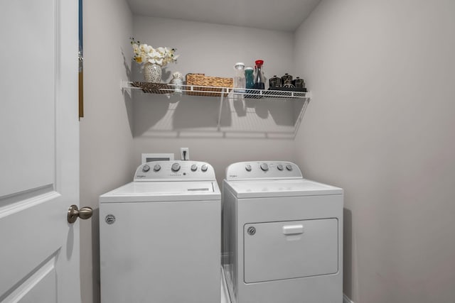 clothes washing area featuring laundry area and separate washer and dryer