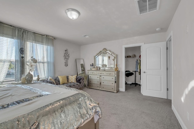 bedroom featuring carpet flooring, visible vents, baseboards, a spacious closet, and a closet