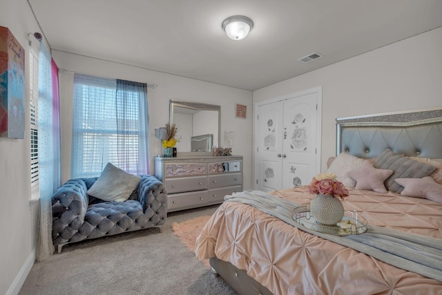 bedroom with carpet floors, visible vents, and baseboards