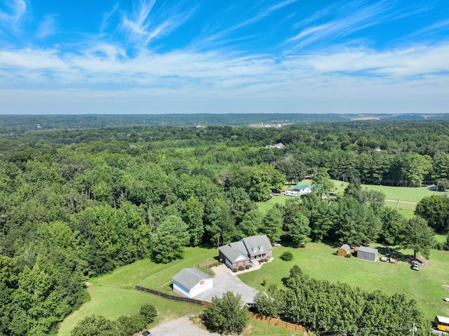 birds eye view of property with a view of trees