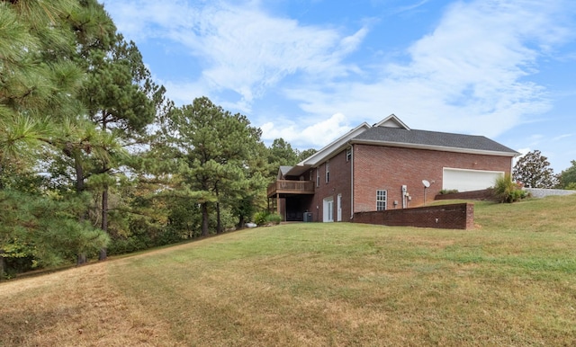 exterior space featuring brick siding, a lawn, and a deck