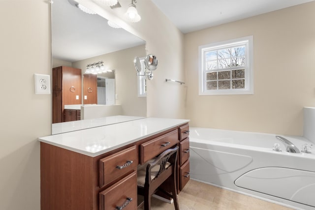 bathroom featuring a garden tub and vanity