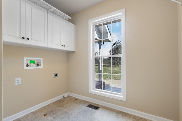 washroom with cabinet space, baseboards, visible vents, washer hookup, and electric dryer hookup