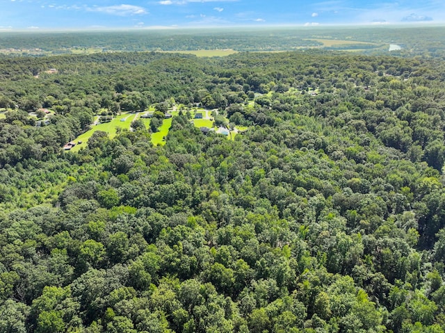 drone / aerial view featuring a wooded view