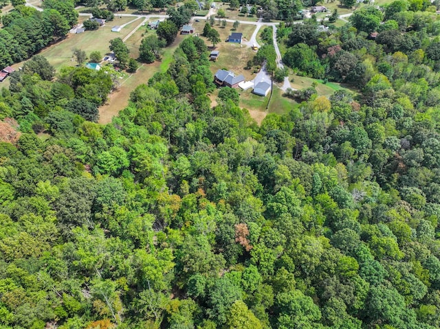 birds eye view of property with a view of trees