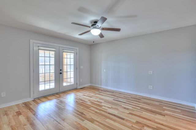 empty room featuring french doors, baseboards, ceiling fan, and light wood finished floors