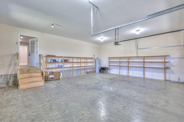 garage with electric water heater and a garage door opener