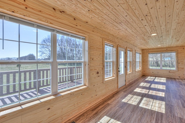 unfurnished sunroom featuring wooden ceiling and a wealth of natural light