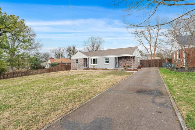 view of front of house featuring aphalt driveway, a front yard, and fence