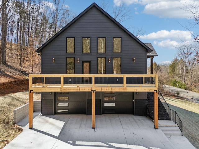 view of front of home featuring stairway and a deck