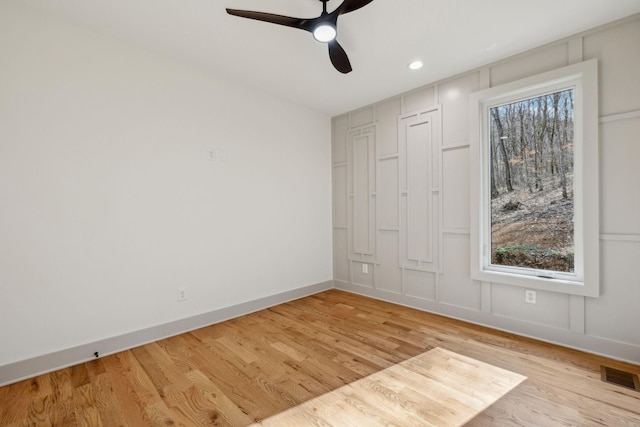 unfurnished bedroom featuring baseboards, multiple windows, visible vents, and light wood-style floors