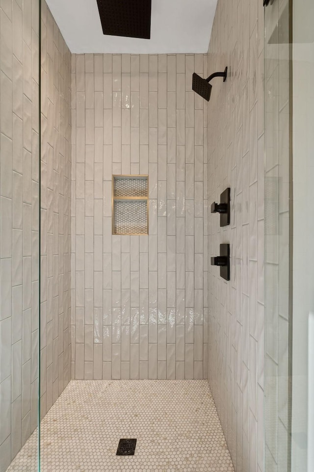 bathroom with a tile shower