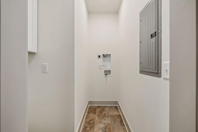 clothes washing area featuring hookup for a washing machine, laundry area, baseboards, electric panel, and electric dryer hookup