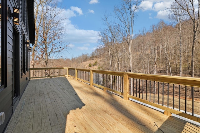 wooden terrace with a view of trees