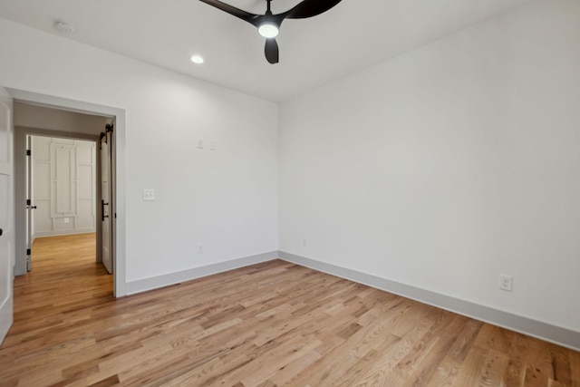 spare room with recessed lighting, light wood-type flooring, a ceiling fan, and baseboards