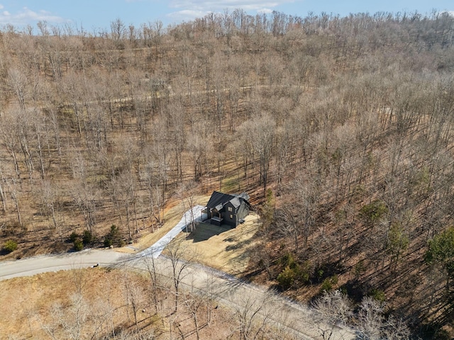 drone / aerial view featuring a view of trees