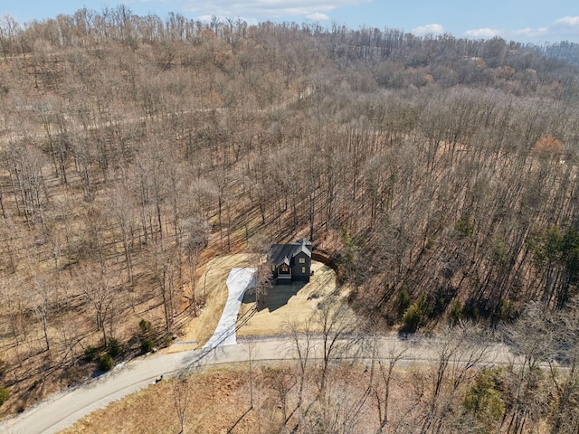 birds eye view of property with a view of trees