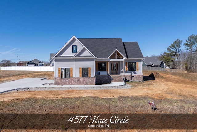 craftsman inspired home featuring brick siding and fence