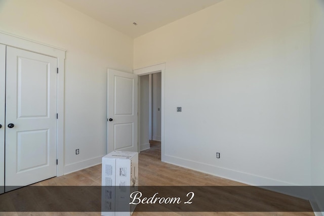 unfurnished room featuring light wood-type flooring and baseboards