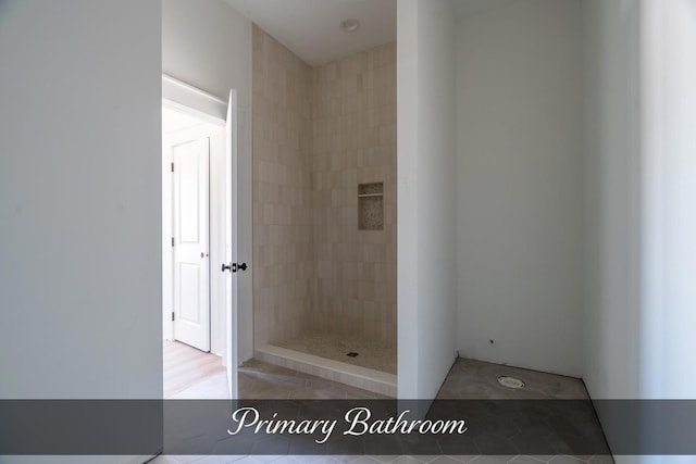 full bath featuring a tile shower and tile patterned floors