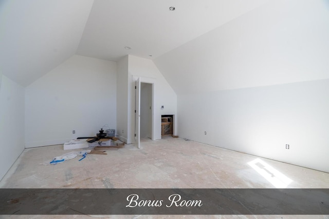 additional living space featuring lofted ceiling