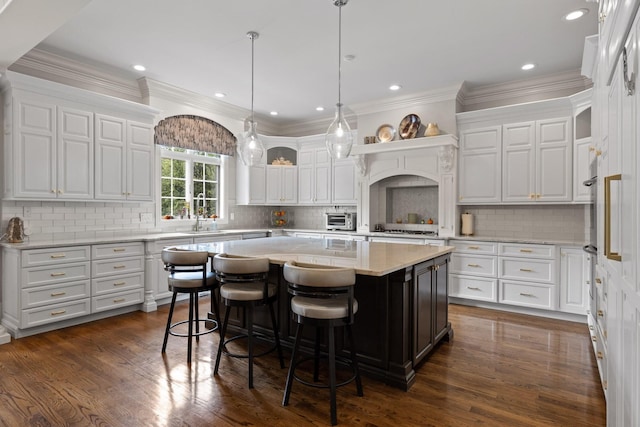 kitchen with dark wood-style flooring, a center island, and white cabinets