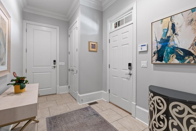 foyer entrance with ornamental molding, light tile patterned flooring, and baseboards