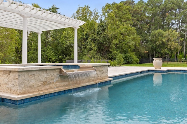 outdoor pool with a hot tub, fence, and a pergola