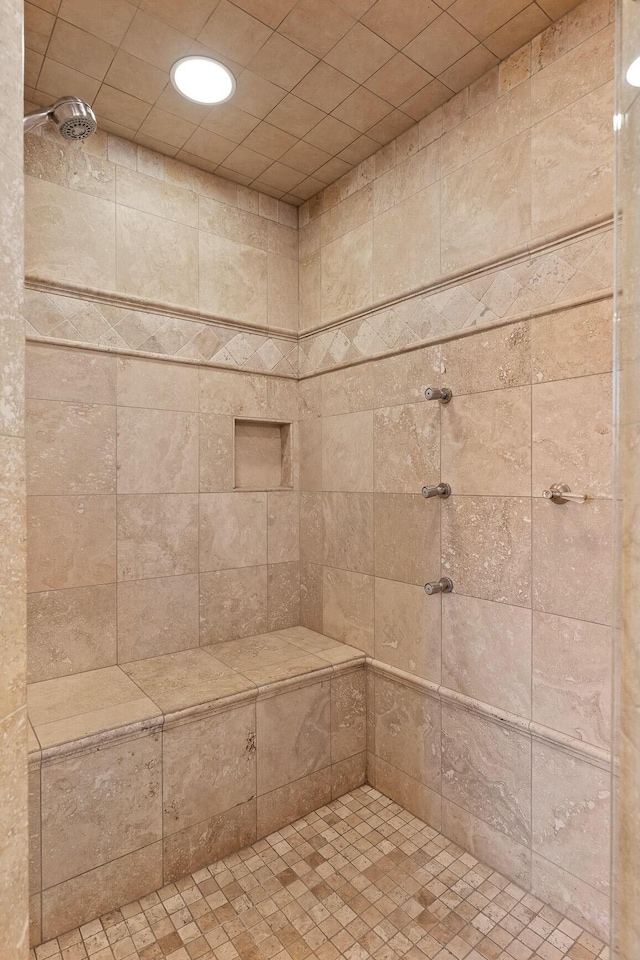 full bath featuring tiled shower