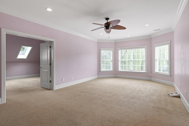 spare room featuring light carpet, a healthy amount of sunlight, and ornamental molding