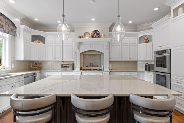 kitchen featuring stainless steel appliances, dark wood-style flooring, a kitchen island, white cabinets, and open shelves