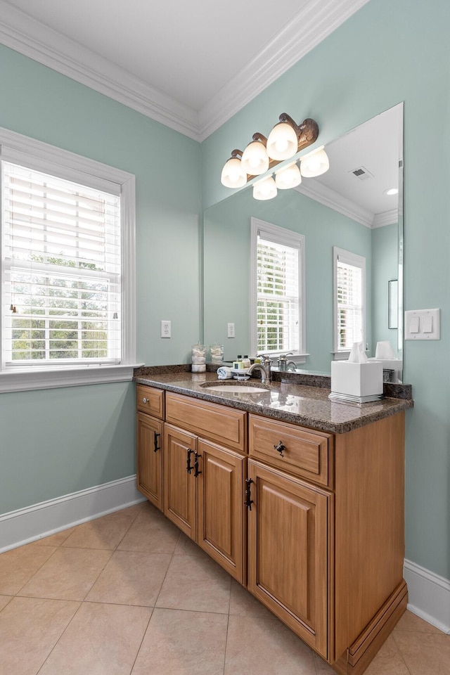 bathroom featuring ornamental molding, visible vents, baseboards, and tile patterned floors