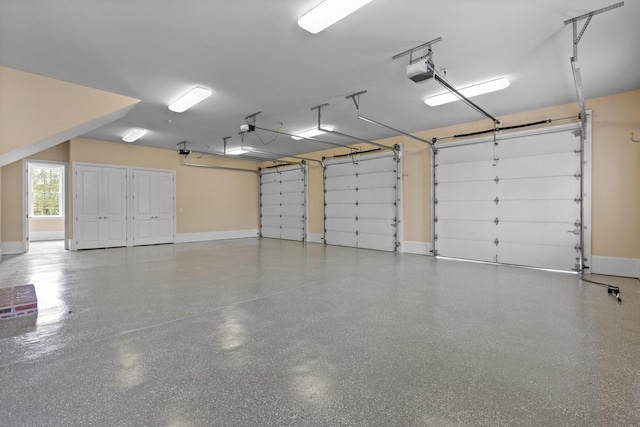 garage with baseboards and a garage door opener