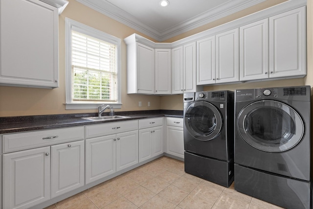 clothes washing area with light tile patterned floors, cabinet space, ornamental molding, a sink, and independent washer and dryer