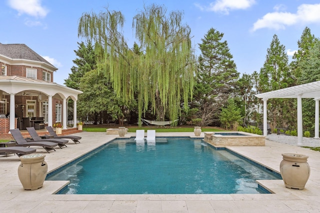 outdoor pool featuring a pergola, a patio, and an in ground hot tub