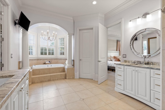 bathroom with crown molding, decorative columns, vanity, tile patterned flooring, and a bath