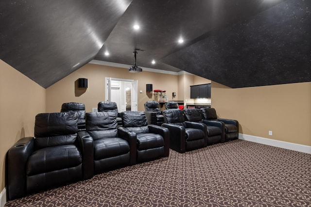 carpeted cinema room with ornamental molding, lofted ceiling, baseboards, and recessed lighting