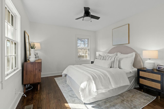 bedroom with visible vents, ceiling fan, baseboards, and wood finished floors