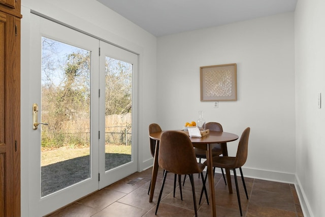 tiled dining space with visible vents and baseboards