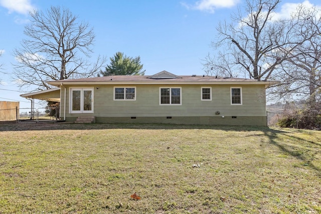 rear view of property with entry steps, a yard, crawl space, and fence