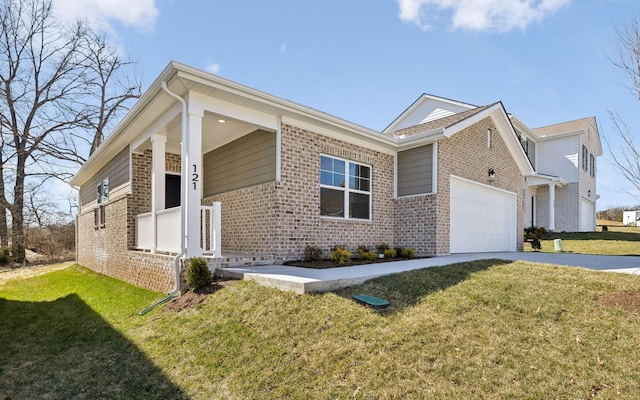 view of front of property featuring an attached garage, brick siding, concrete driveway, and a front yard