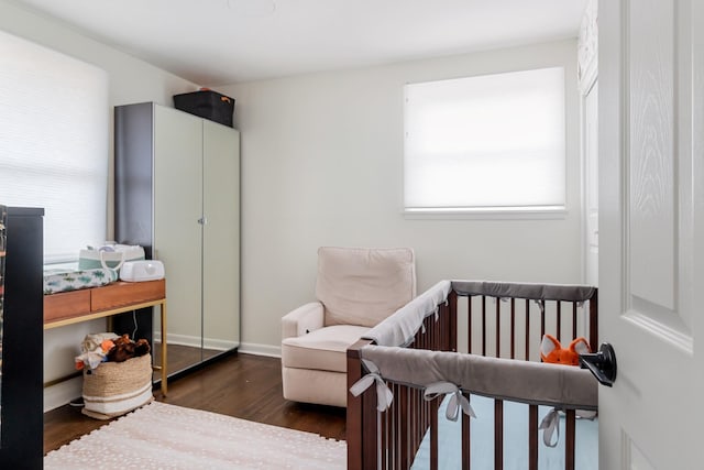 bedroom featuring wood finished floors and baseboards