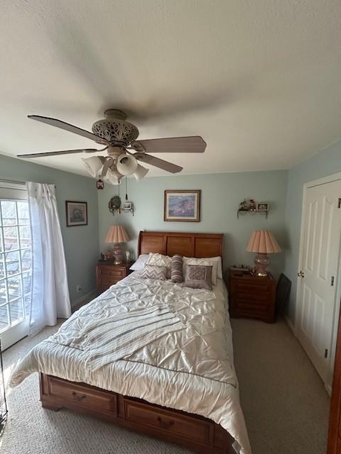 bedroom featuring a ceiling fan and light colored carpet