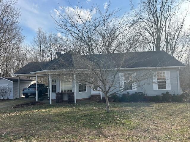 view of front of house featuring a front yard and an attached carport