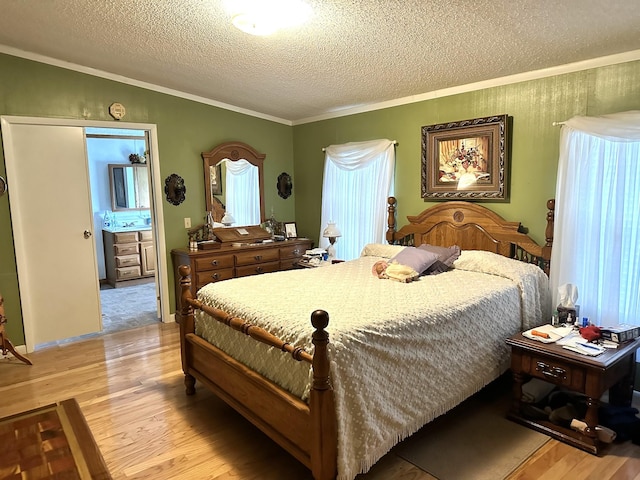 bedroom featuring lofted ceiling, light wood finished floors, a textured ceiling, and crown molding