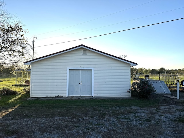 view of outbuilding with an outdoor structure and fence